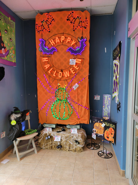 Twinkling LED outdoor decoration for Halloween. Shaped like a giant green and purple spider.