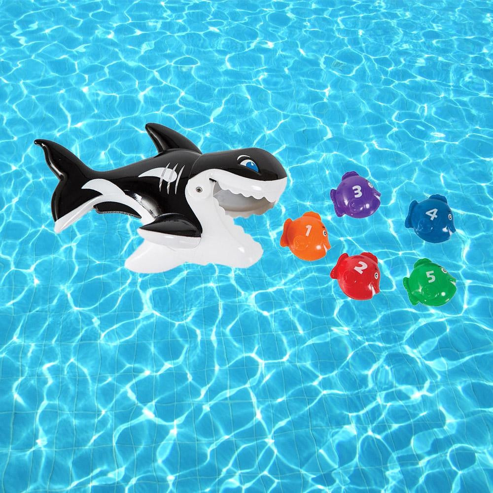 Pool game shaped like a whale whose mouth opens up. Kids try to use the whale's mouth to swallow up the little toy fish.