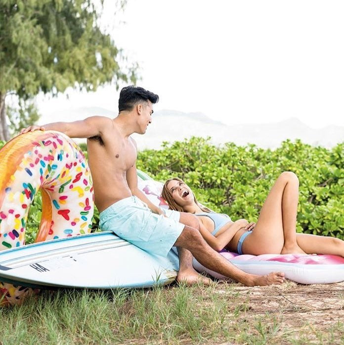 Inflatable inner tube designed to look like a donut with frosting and multi-colored sprinkles.