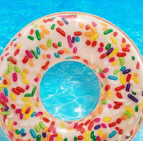 Inflatable inner tube designed to look like a donut with frosting and multi-colored sprinkles.