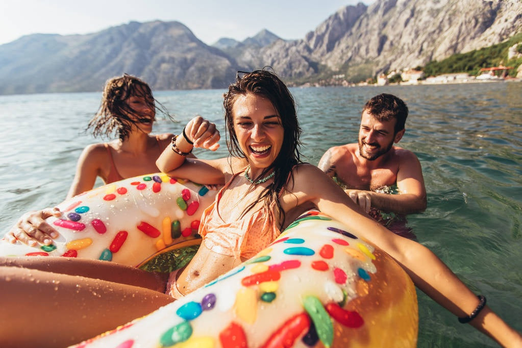 Inflatable inner tube designed to look like a donut with frosting and multi-colored sprinkles.