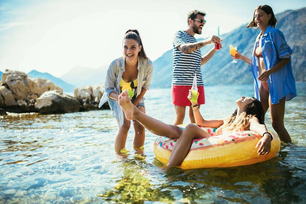 Inflatable inner tube designed to look like a donut with frosting and multi-colored sprinkles.