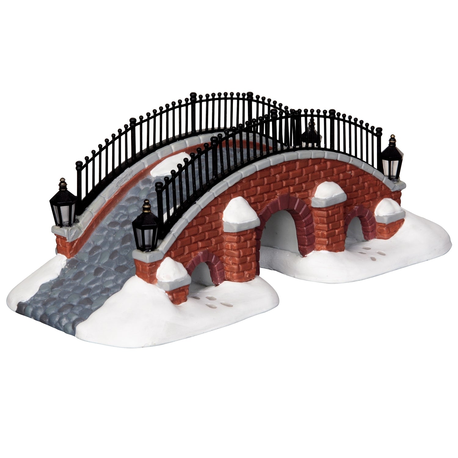 Porcelain lighted building for a Lemax display. Designed to look like a brick bridge with a metal fence. The path on the bridge is made of stone. There's snow on the ground and you can see footsteps in the snow.