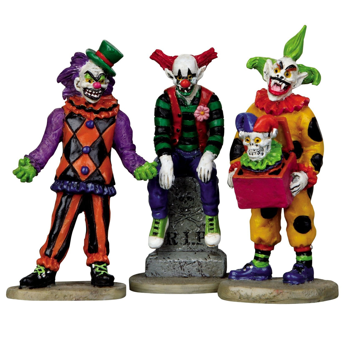 Three polyresin figurines for a Lemax Spooky Town display. Designed to look like three scary clowns. One of them is sitting on a tombstone that reads RIP.