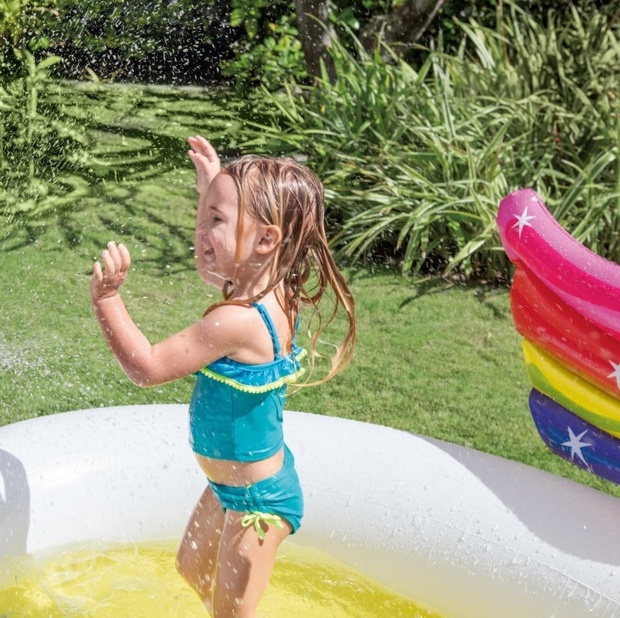 Inflatable pool for kids shaped like a rainbow unicorn.