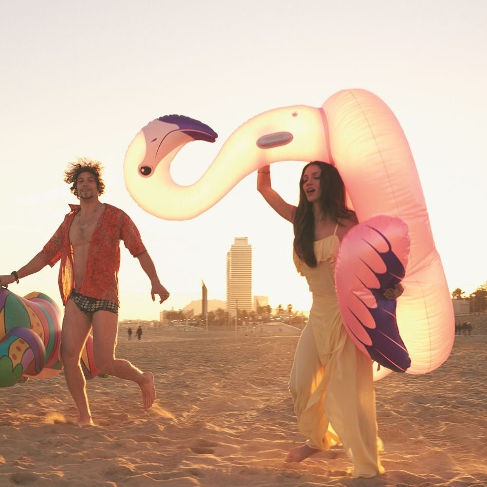 Ride on pool inflatable shaped like a pink flamingo.