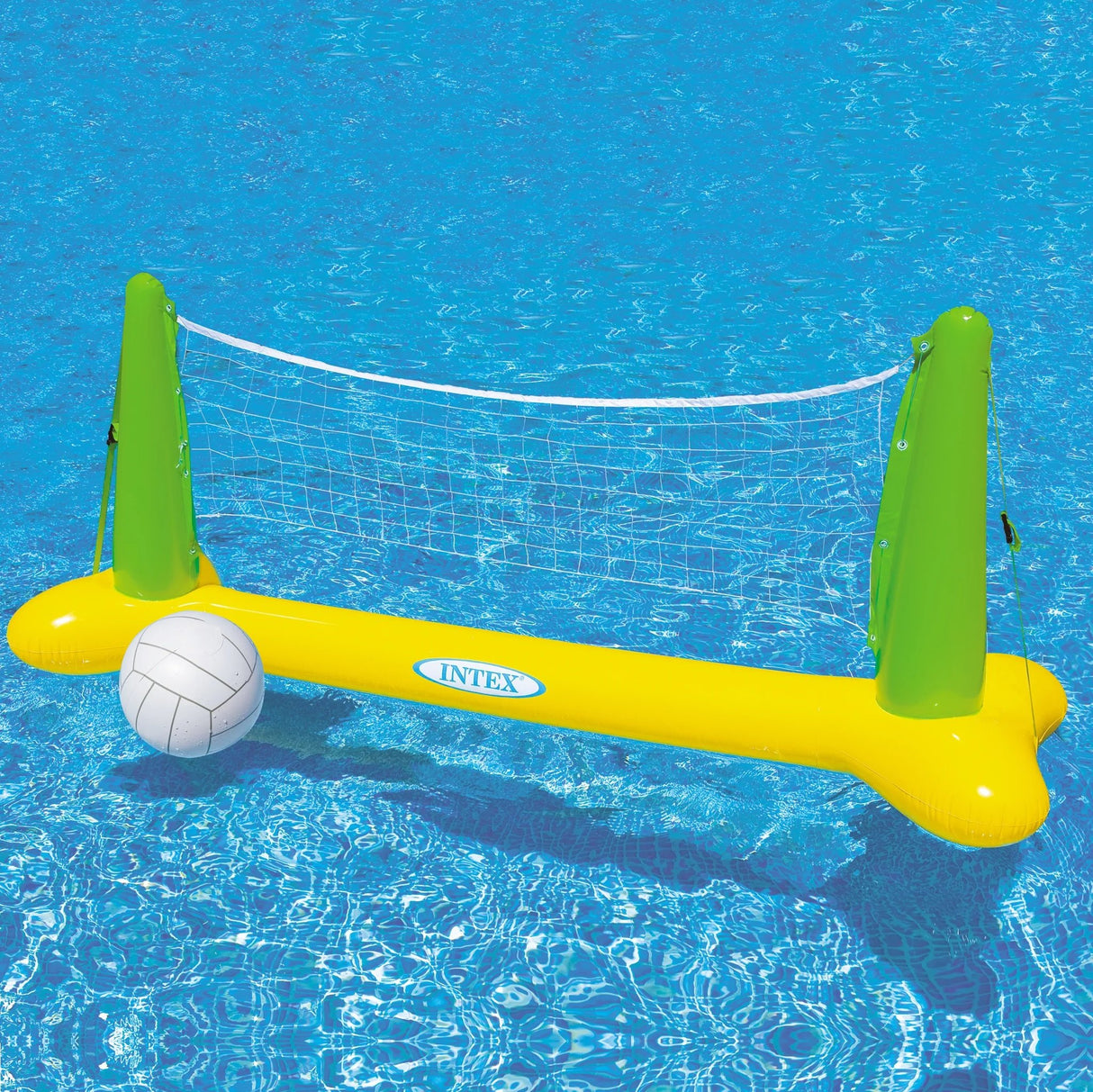 This is a lifestyle image showing the inflatable volleyball net and inflatable volleyball in a pool. This net is lime green and yellow.