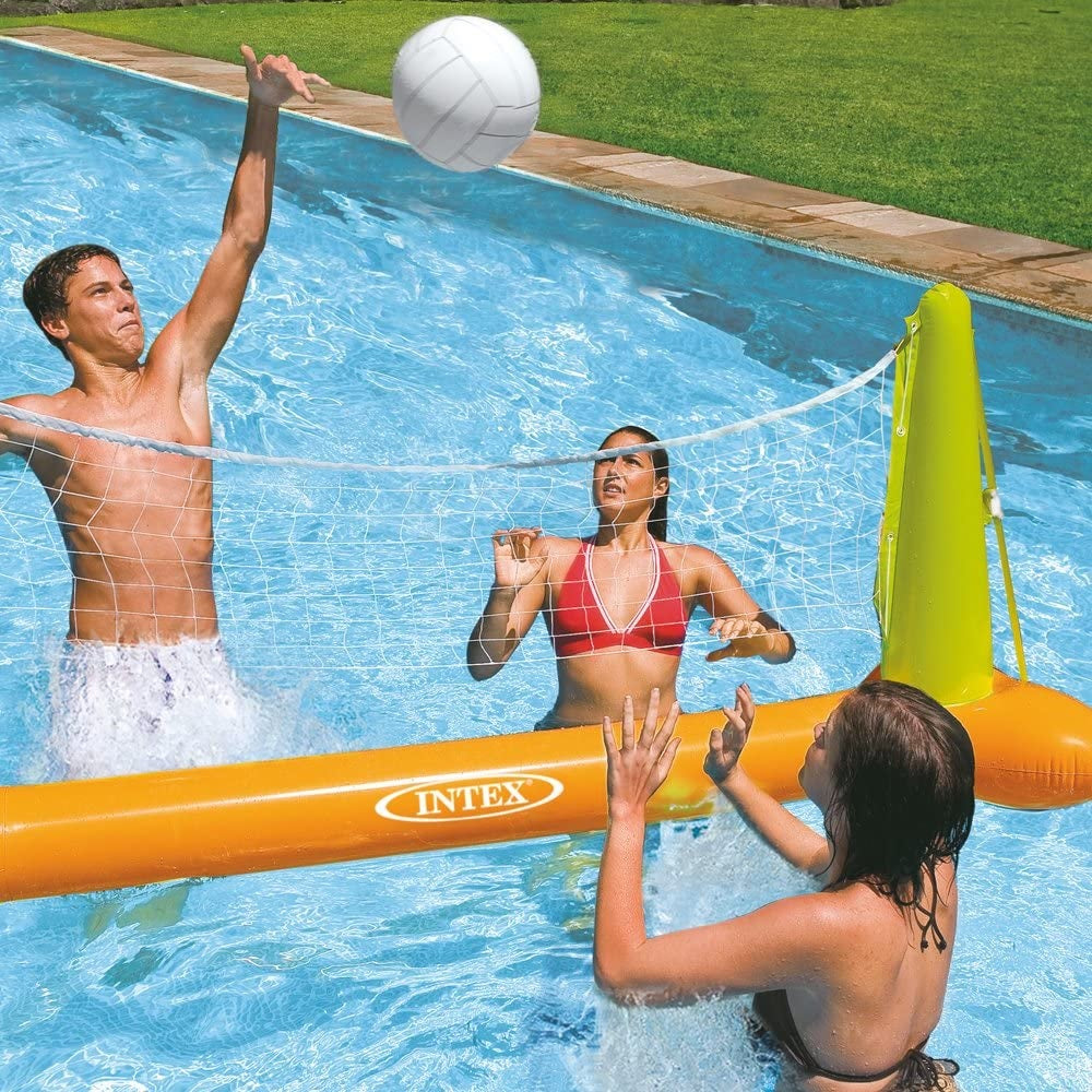 This is a lifestyle image showing three people playing volleyball in the pool.
