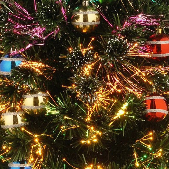 4 ft. fiber optic tree with multi-colored, glittered ball ornaments and a gold base.