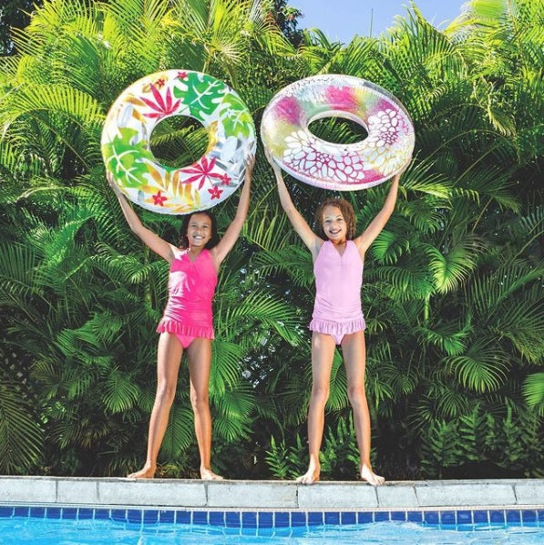 Inner tube detailed with tropical leaves and the other is detailed with pink and yellow flowers.