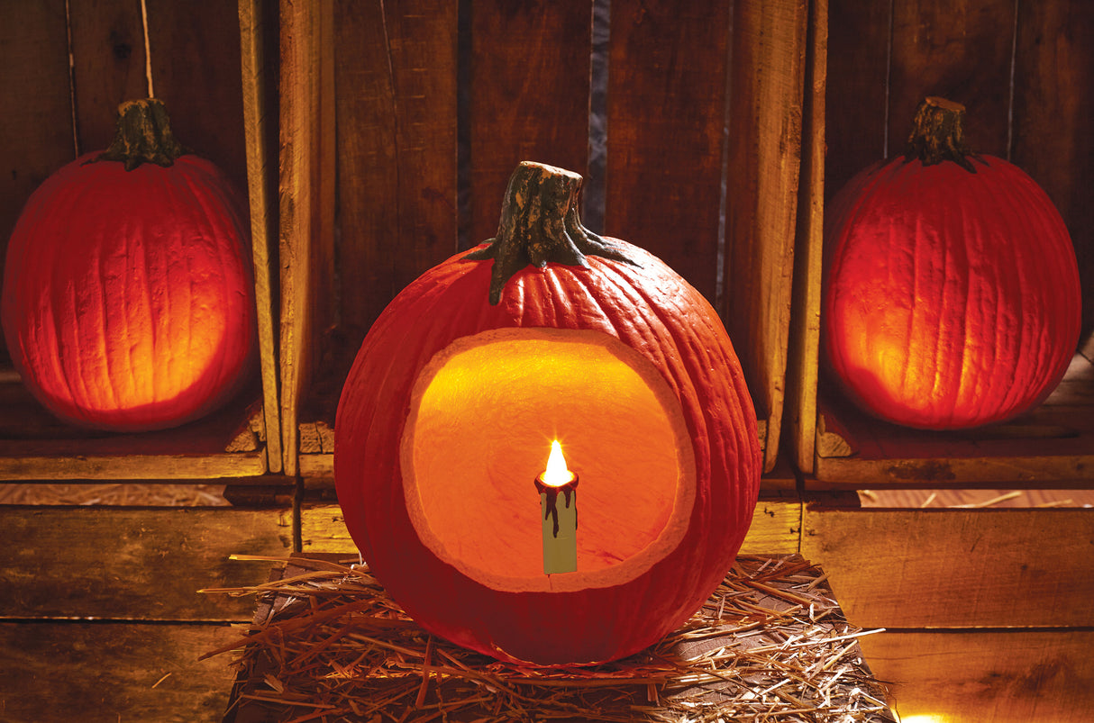 Battery-operated white candle with red wax dripping off the top. Designed to be placed inside a pumpkin/jack-o-lantern.