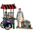 Polyresin figurines for a Lemax display. Designed to look like a food cart vendor. The sign on the cart reads "SPECIAL EYEBALL POPPERS!" And the cart reads "BRAINS AND FRESH HAND PIES." The vendor is wearing an apron with blood splattered on it and he's standing next to a pot with a hat peaking out. There's a foot in a boot next to the pot.