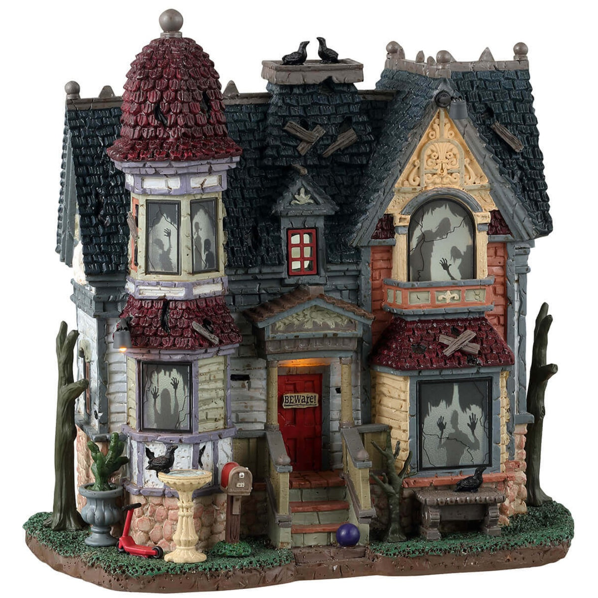 Resin lighted building for a Lemax display. Designed to look like a run down, Victorian-era style mansion. There are ghost shadows in every window and crows all over.