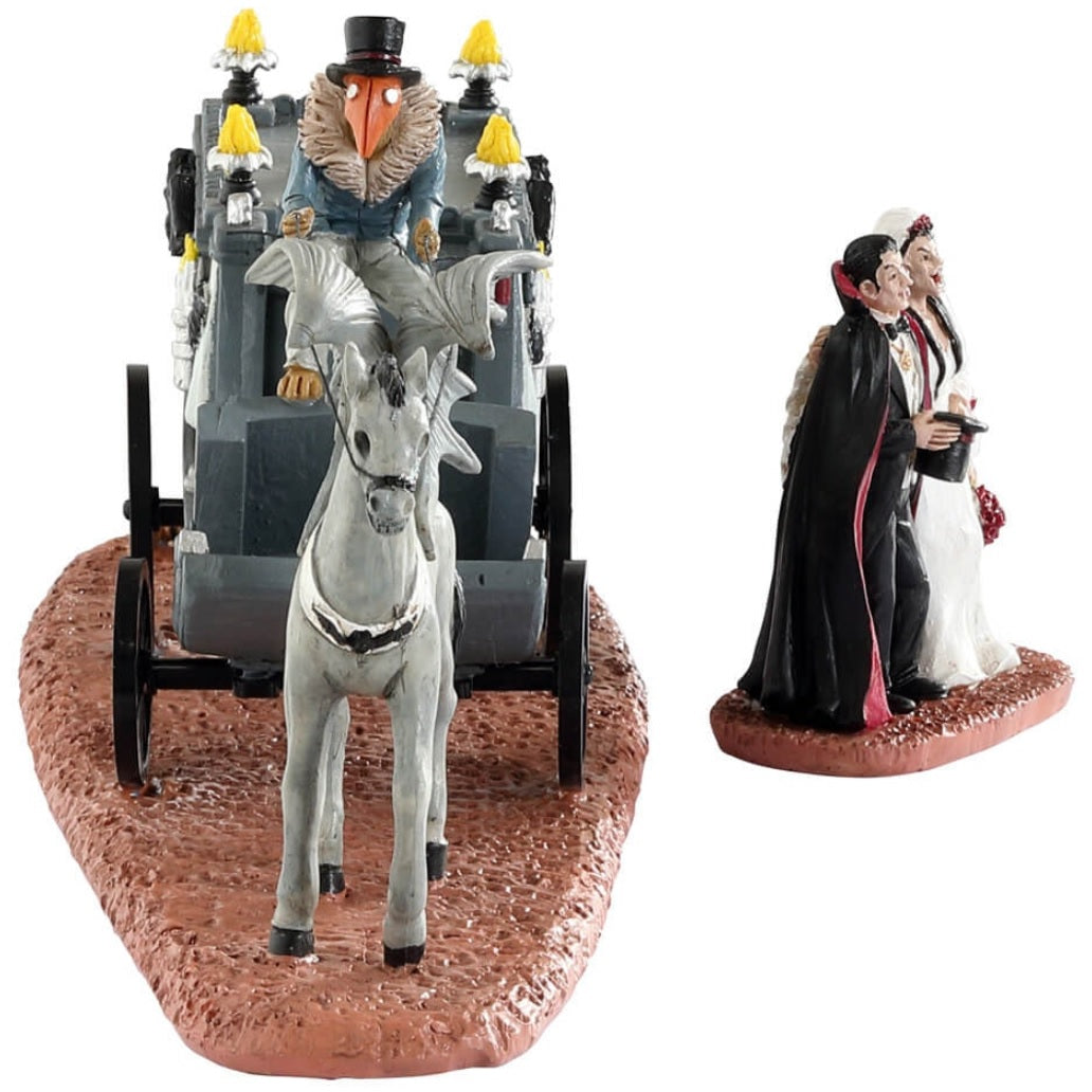 Resin table accent for a Lemax Spooky Town Village display. Designed to look like a wagon carrying a coffin. The wagon is being pulled by a horse with wings. There's a vampire couple that have just gotten married standing outside.
