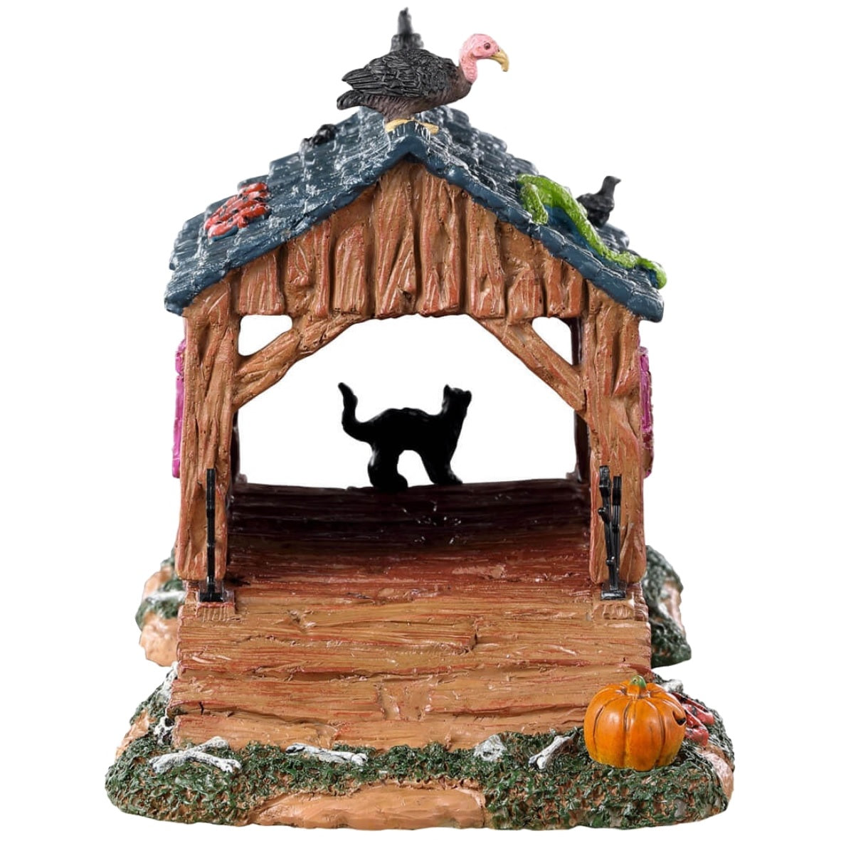 Resin village table accent for a Lemax display. Designed to look like a rotted out, covered bridge. There's a green snake and a vulture on the roof. There's a black cat and a bunch of pumpkins and bones on the ground.