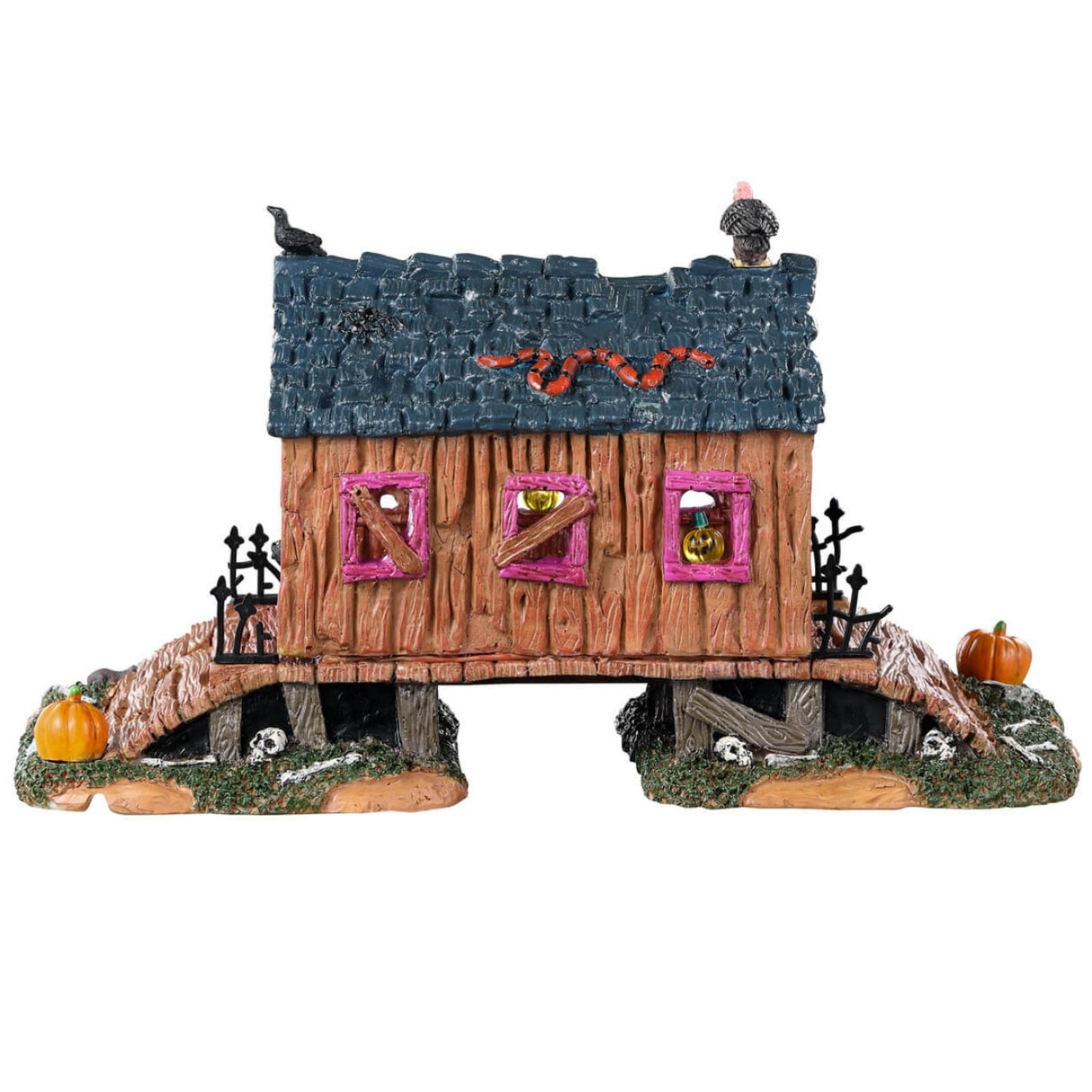Resin village table accent for a Lemax display. Designed to look like a rotted out, covered bridge. There's a green snake and a vulture on the roof. There's a black cat and a bunch of pumpkins and bones on the ground.
