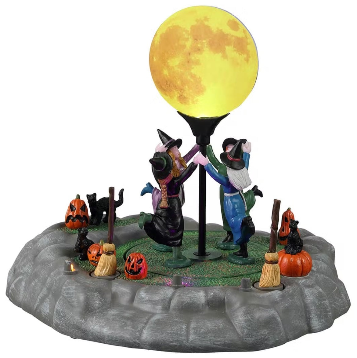 Resin village accent for a Lemax Spooky Town display. Designed to look like four witches holding hands and dancing underneath a giant moon. There are brooms and carved pumpkins and black cats on the ground.