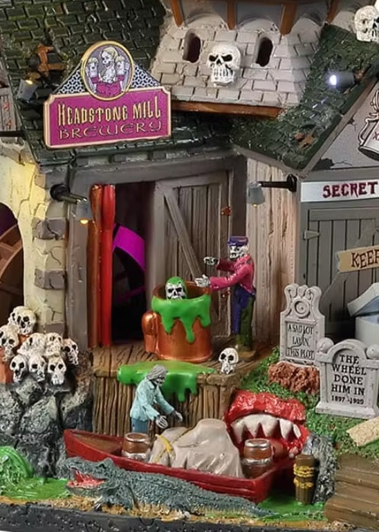 Resin building for a Lemax display. Designed to look like a creepy cabin connected to windmill and a water wheel. There are tombstones and bone accents.