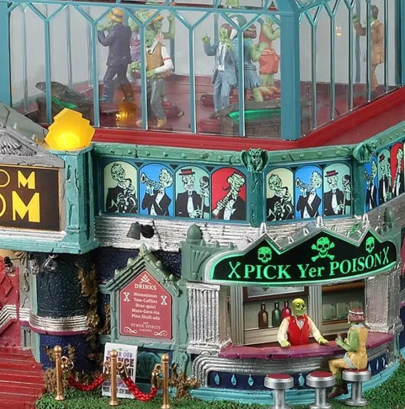 Resin lighted building for a Lemax Spooky Town display. Designed to look like an art deco themed dance club. There's a red carpet and a red velvet rope. There's a bar on the outside that reads "x PICK YER POISON x." There's a monster behind the bar and a woman sitting on a stool. There's a glass dome on top where you can see all the people dancing inside.