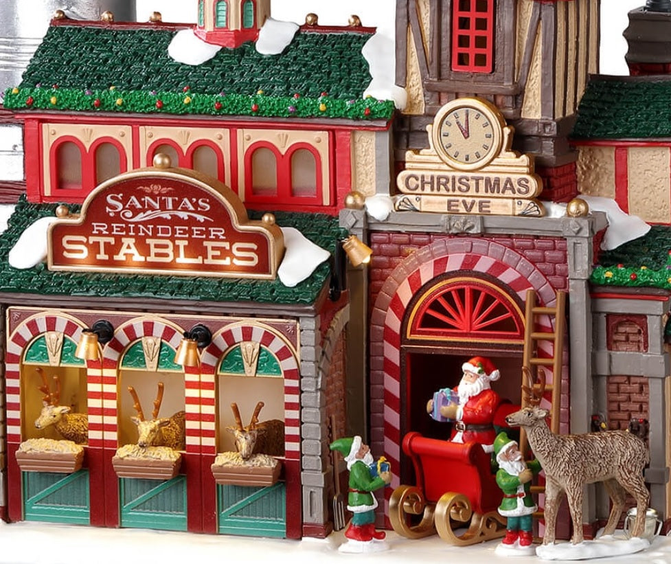 Resin lighted building for a Lemax display. Designed to look like Santa's Reindeer Stables. There are reindeer eating and elves helping Santa Claus get his sleigh ready.