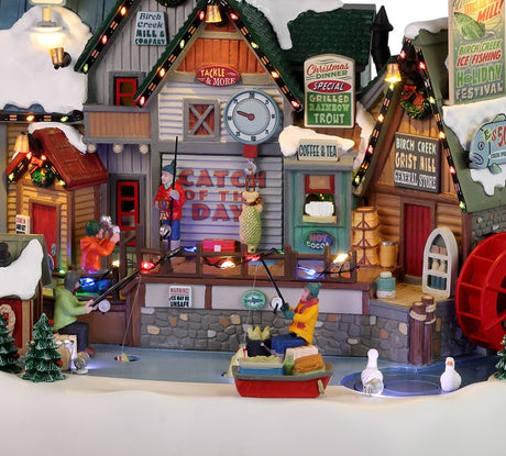 Resin lighted building for a Lemax display. Designed to look like a wooden cabin near an icy river. There's someone ice fishing and someone taking a picture of someone with a fish. There's a water turbine and someone in a boat. You can buy rods and reels, grilled fish and hot chocolate, coffee or tea. You can also celebrate the Birch Creek Ice Fishing Festival at the General Store.