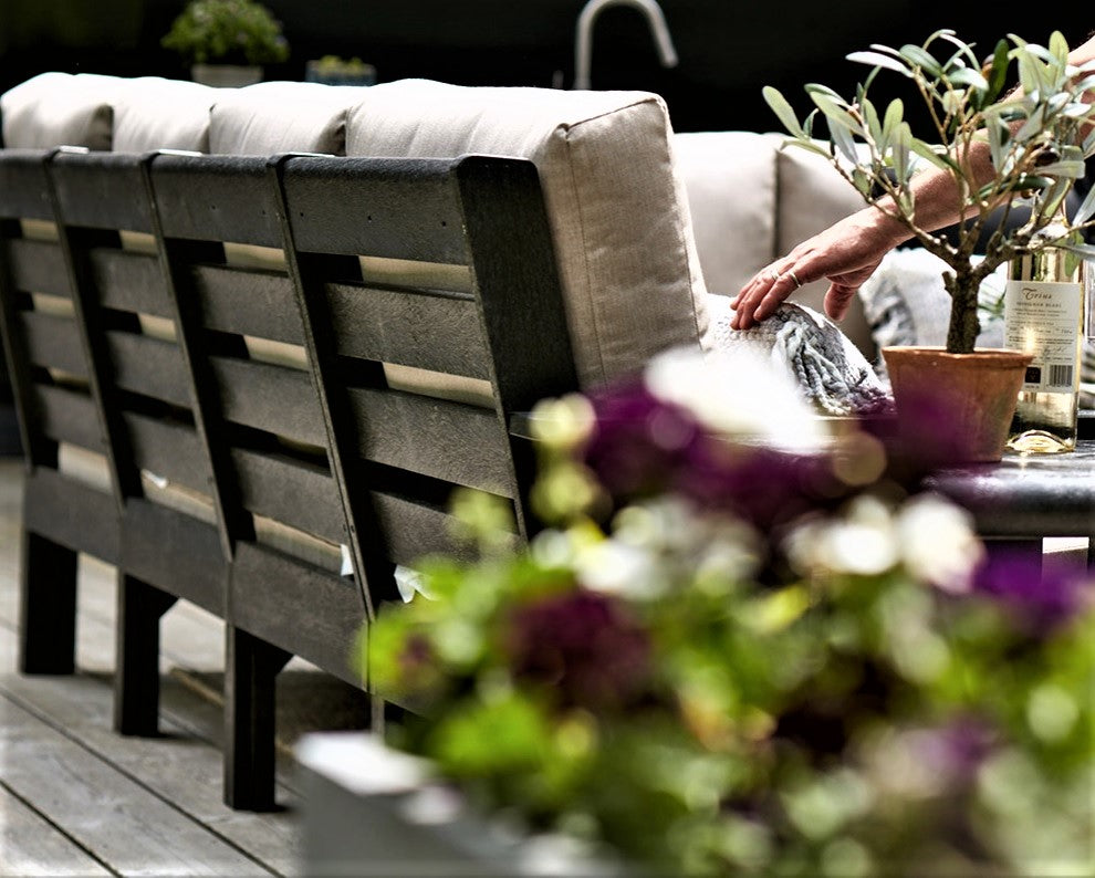 Side view of a cushioned patio sectional couch