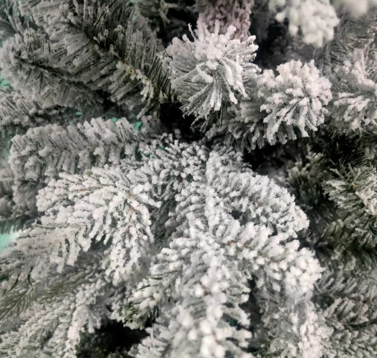 Artificial tree pre-lit with Starry lights. Branches are covered in white to appear covered in snow.