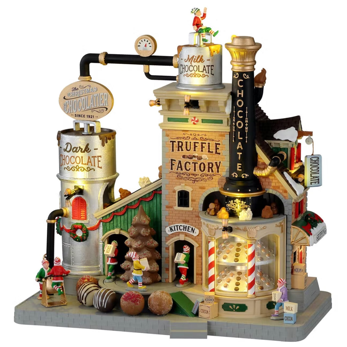 Polyresin lighted building for a Lemax display. Designed to look like a Christmas themed factory. There's an elf sitting on top of the roof. Signs read "Milk Chocolate," "Dark Chocolate," "Truffle Factory, "Kitchen" and "Chocolate." There's a display of truffles in the front window and a bunch of elves working hard.