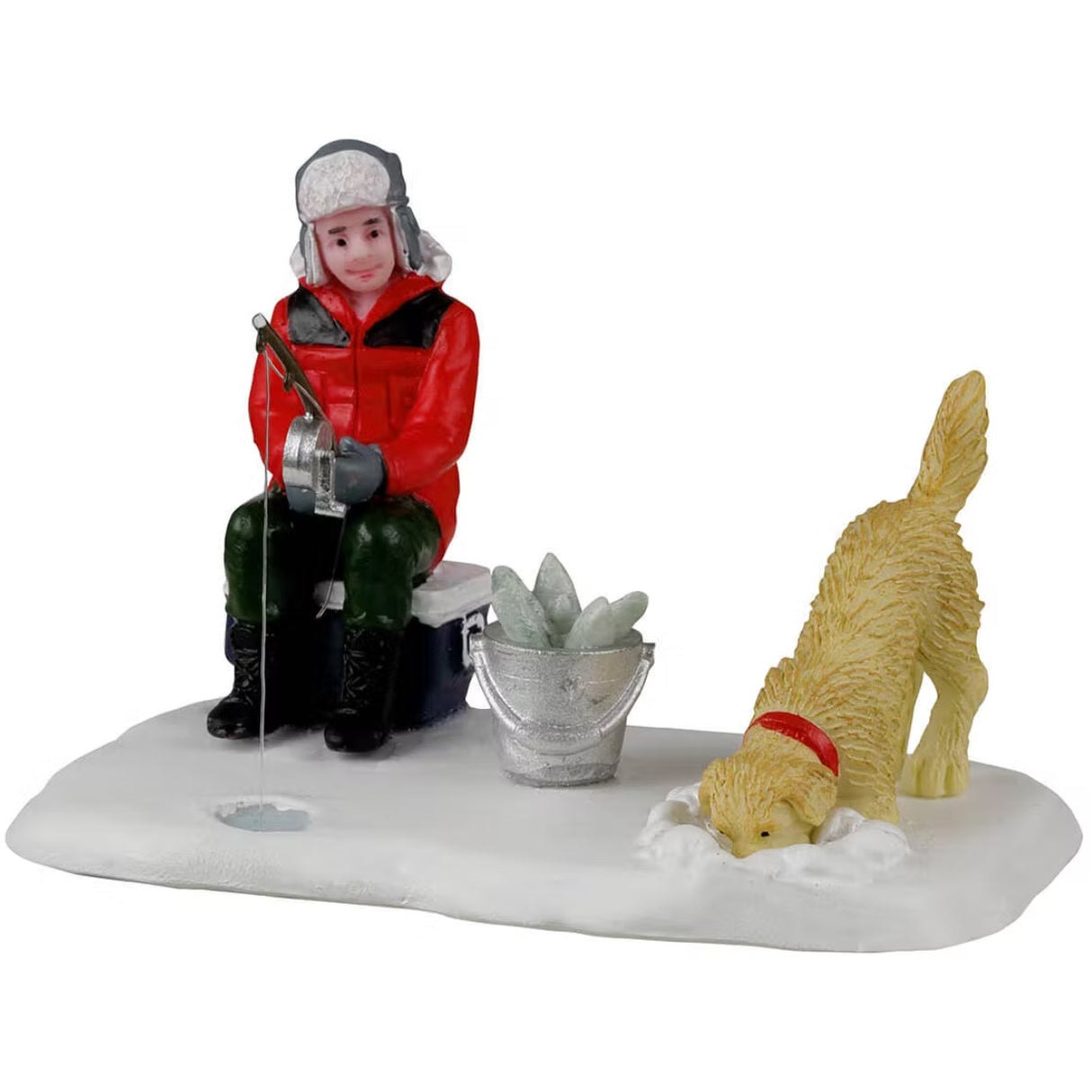 A resin figure for a Lemax display. Designed to look like a person ice fishing while sitting on a cooler. There's a bucket of fish next to him and a dog burying its face in the snow.