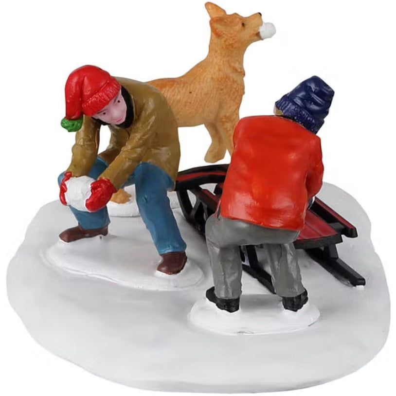 Resin village accent for a Lemax display. Designed to look like two boys and a dog collecting snowballs and putting them on a red sled.