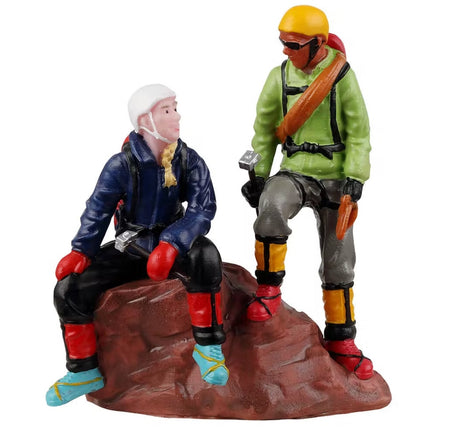 Resin figurine for a Lemax display designed to look like two people taking a break from rock climbing.