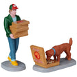 Resin figurines for a Lemax display. Designed to look like a pizza delivery man holding five boxes of pizza. There's an open box of pizza on the ground and a dog taking a sniff. The pizza boxes read "Top Pizza."