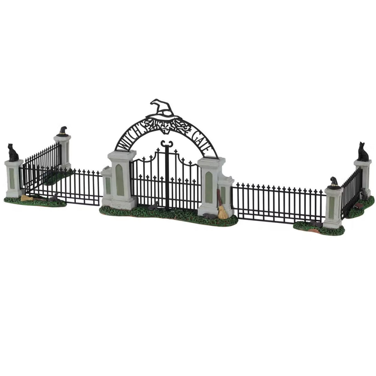 Polyresin village accessory for a Lemax display. Designed to look like an iron fence on patches of grass. There are four columns with witch hat and black cat statues on top. The gate reads "Witch's Gate" and there's a broom leaning against it.