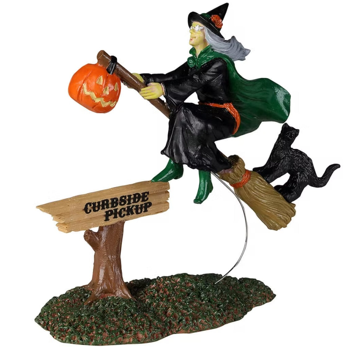 Polyresin figurine for a Lemax Spooky Town display. Designed to look like a witch riding a broomstick with a jack-o-lantern and a black cat on it. There's a sign on the ground that reads "CURBSIDE PICKUP." She's wearing a black robe, a green robe, green shoes and a black witch hat.