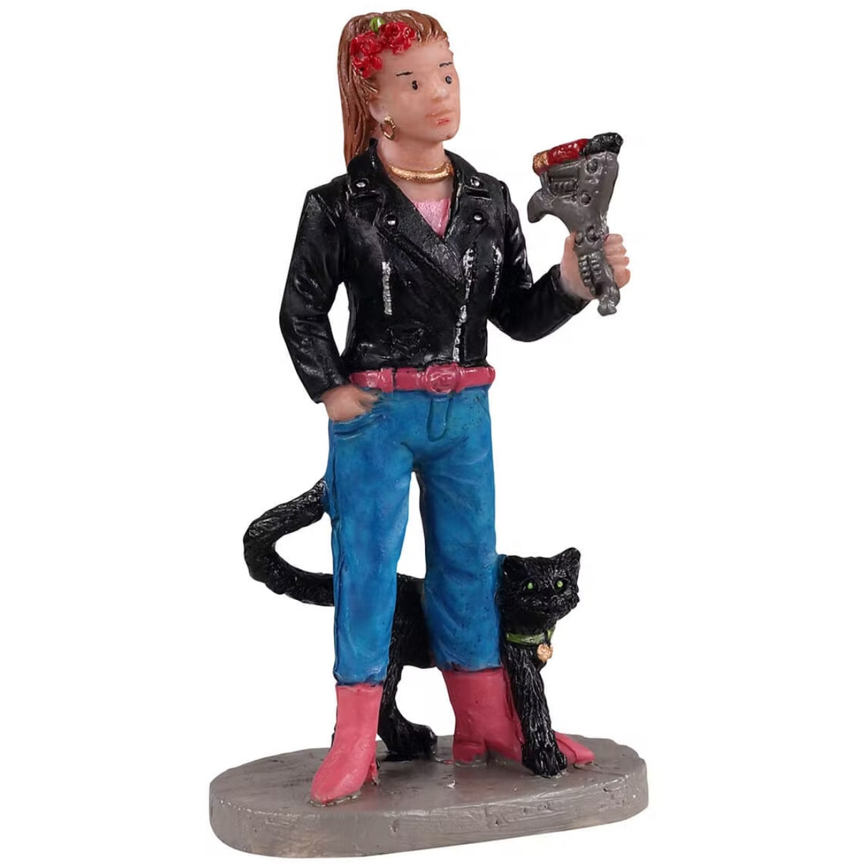 Polyresin figurine for a Lemax display. Designed to look like a woman wearing a black leather jacket, a pink belt, blue jeans and pink boots. She's holding a tattoo machine and there's a black cat rubbing up against her leg.