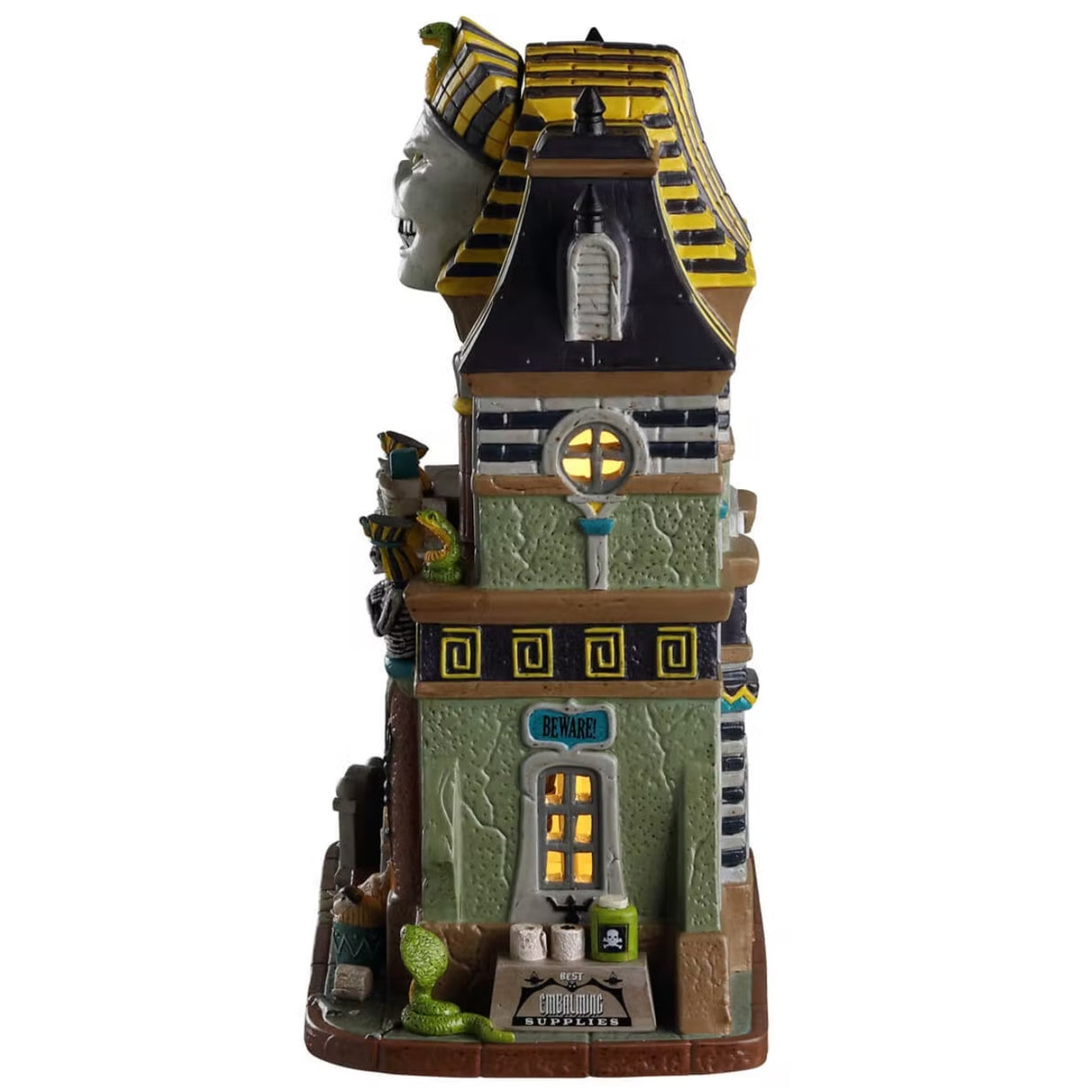 Porcelain lighted building for a Lemax display. Designed to look like a tall, light green building with an Egyptian mummy statue on the roof. There are skeletons, tombstones and snakes.