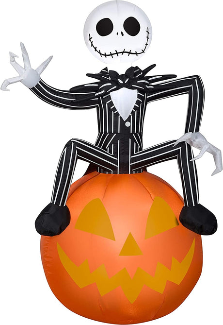 Halloween inflatable shaped like Jack Skellington from the movie The Nightmare Before Christmas. He's sitting on a jack-o-lantern and waving.