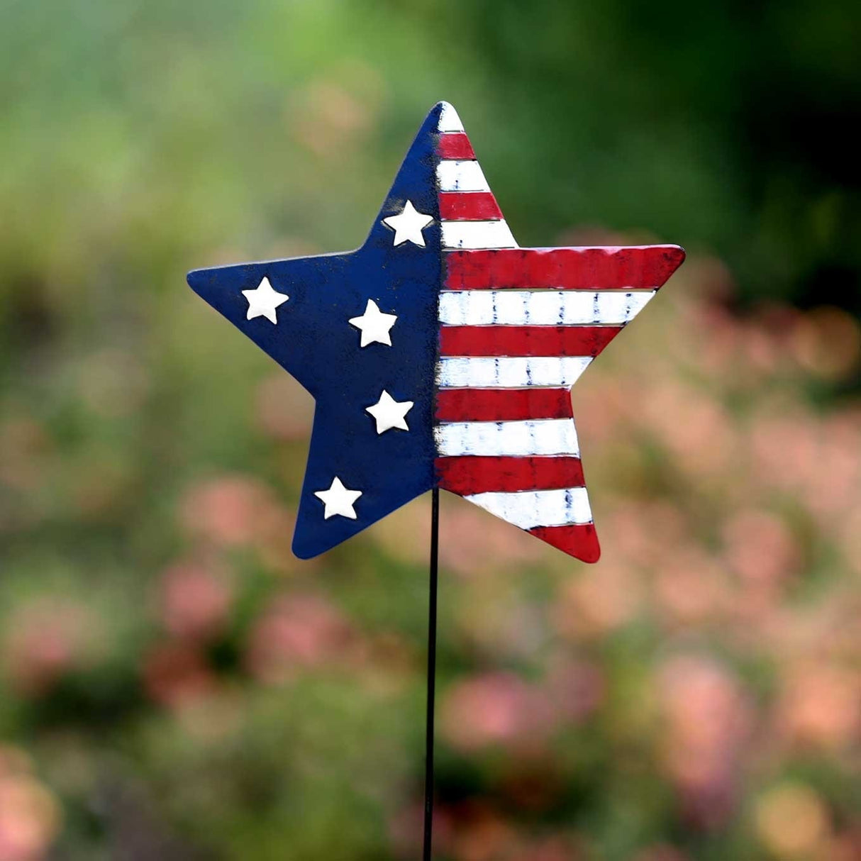 Lawn stake shaped like a star. The left side of the star is blue with white stars. The right side of the star is red and white striped.