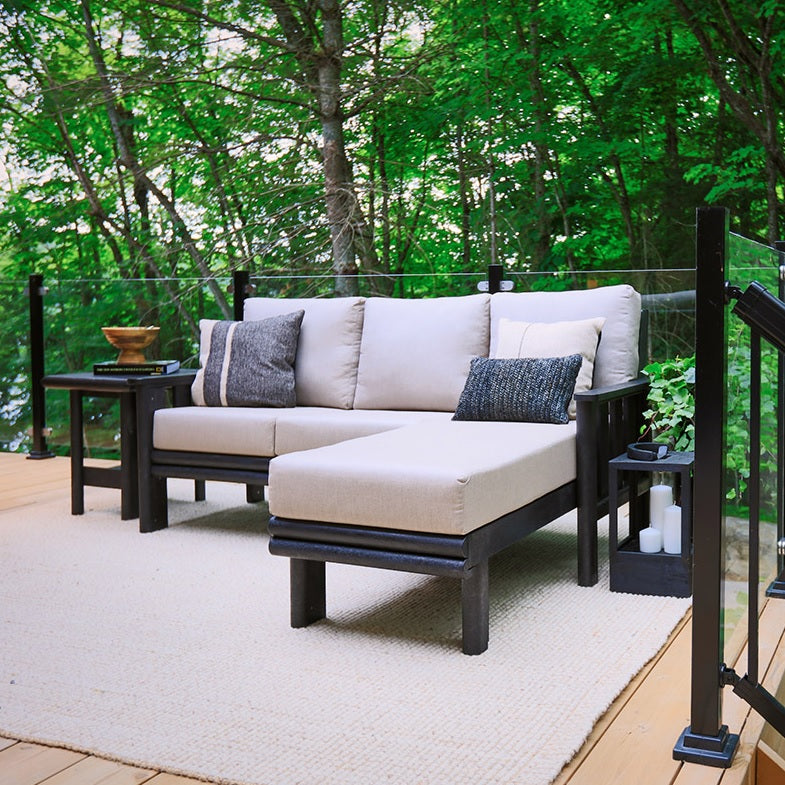 A cushioned patio sectional on a balcony in the woods
