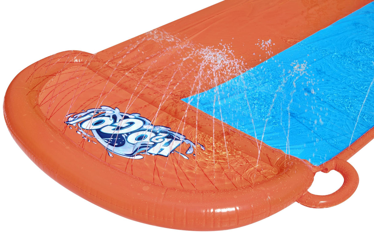 A slip n slide with two lanes that lead into a splash pad.