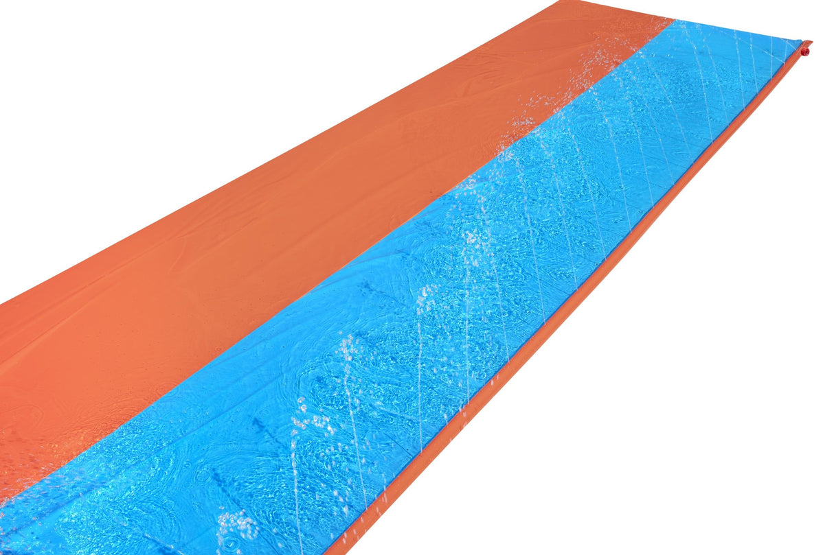 A slip n slide with two lanes that lead into a splash pad.