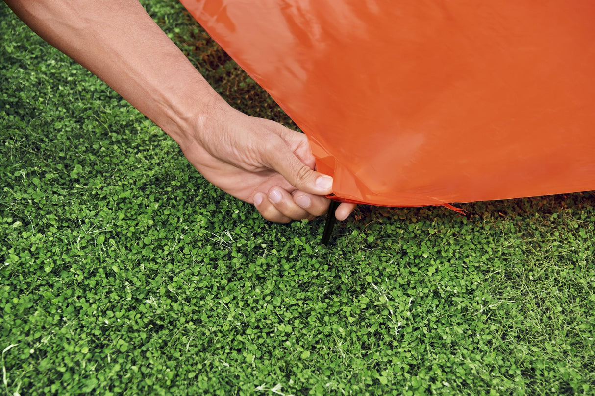 A slip n slide with two lanes that lead into a splash pad.