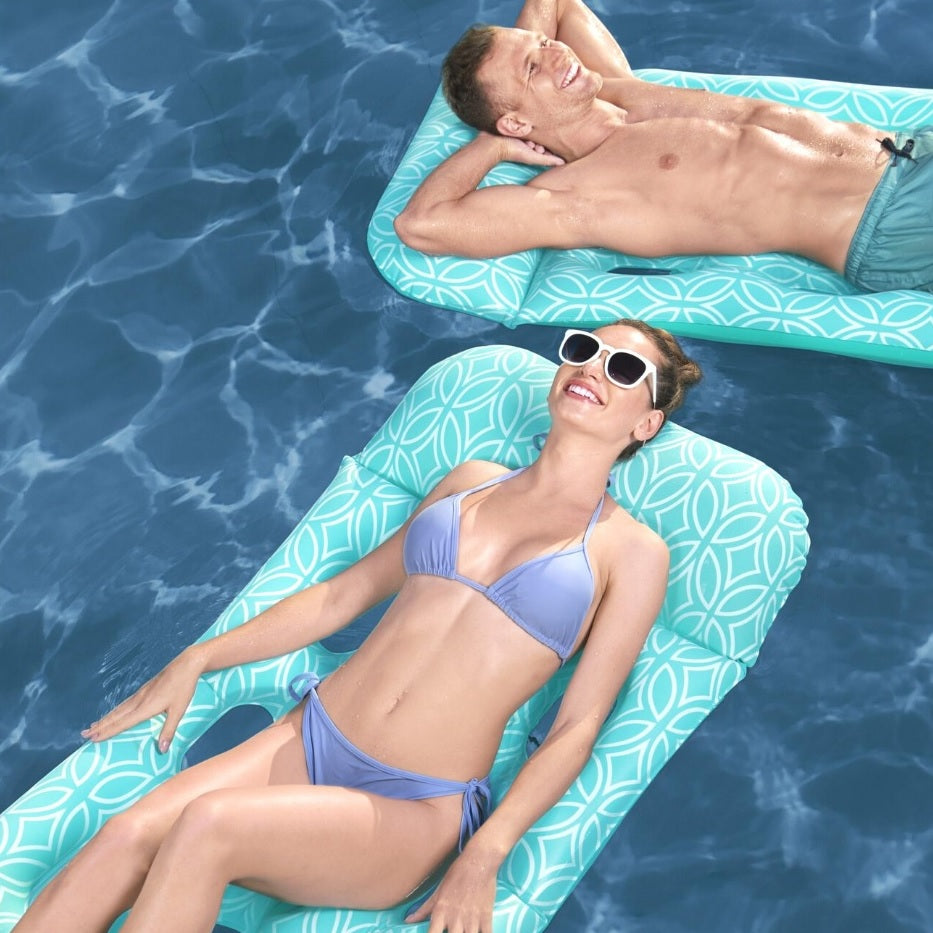 This is a lifestyle image showing two people floating on different mats.