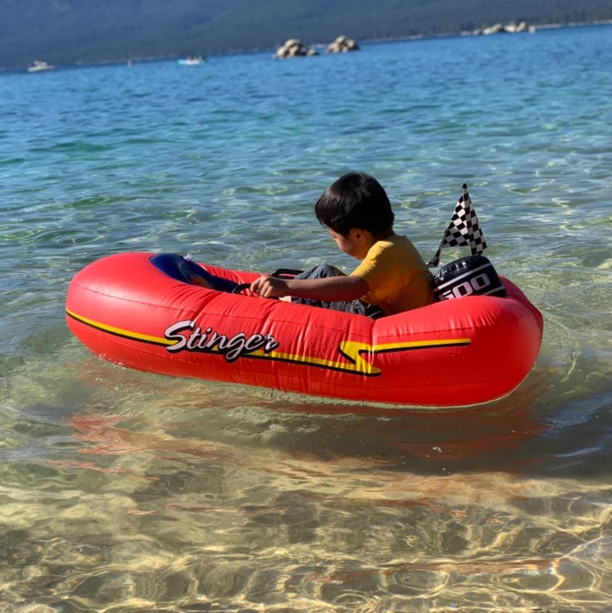 Pool float for kids shaped like a red speedboat.