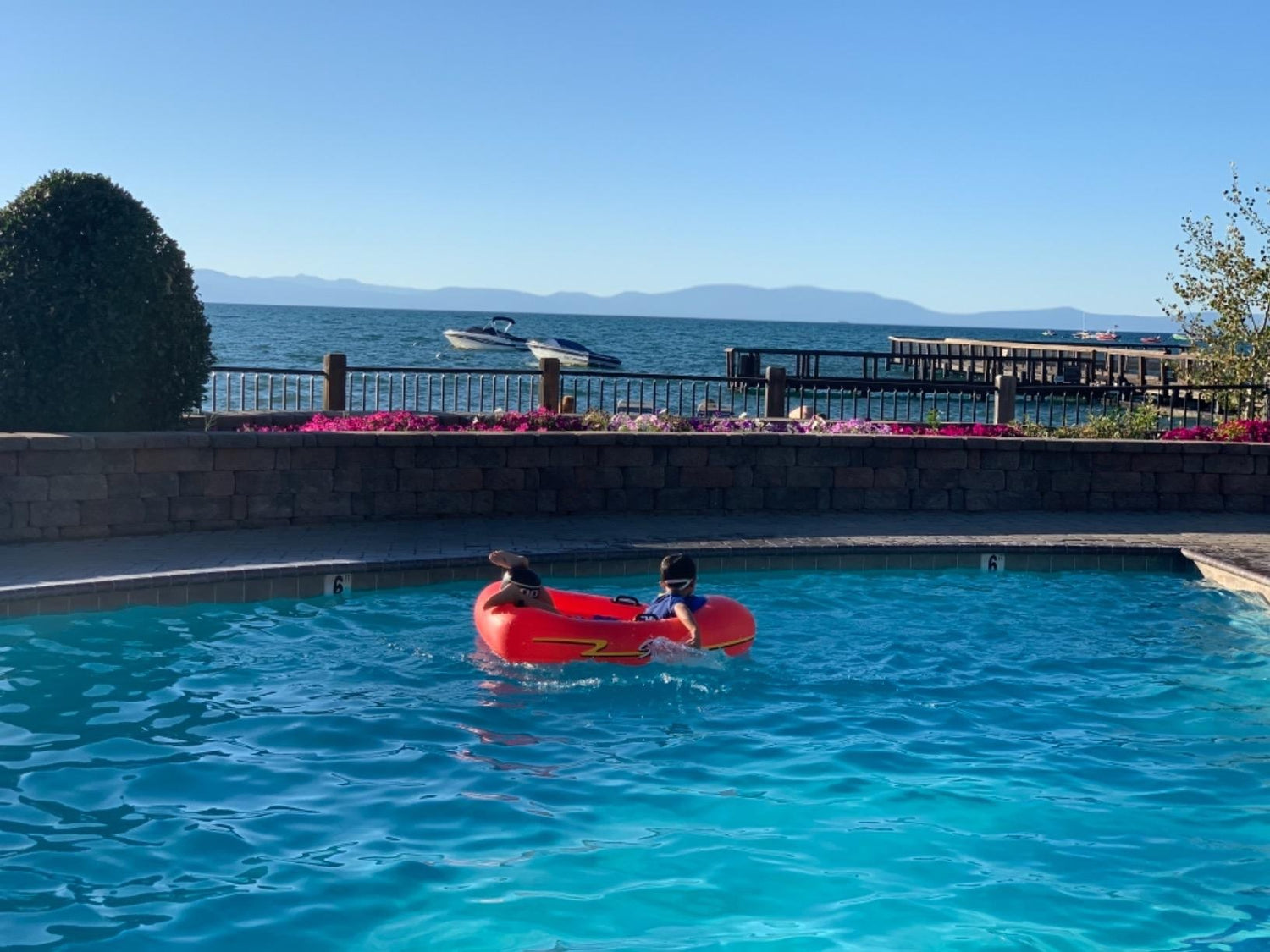 Pool float for kids shaped like a red speedboat.