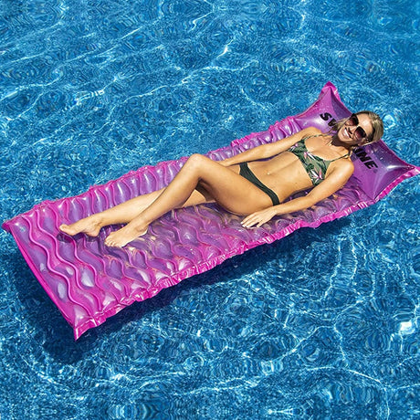 Pink inflatable pool mattress.