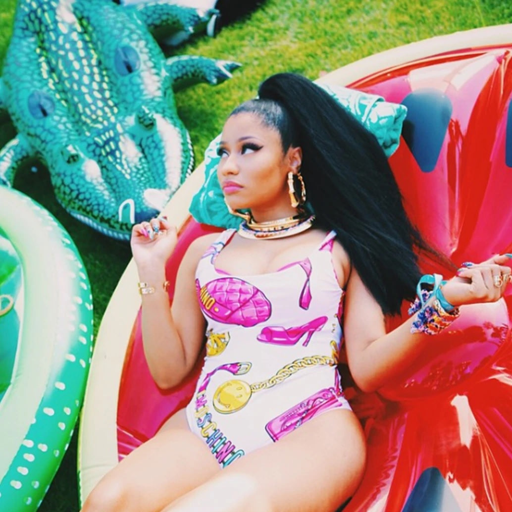 This is a lifestyle image showing Nicki Minaj laying on the watermelon float surrounded by other inflatables.
