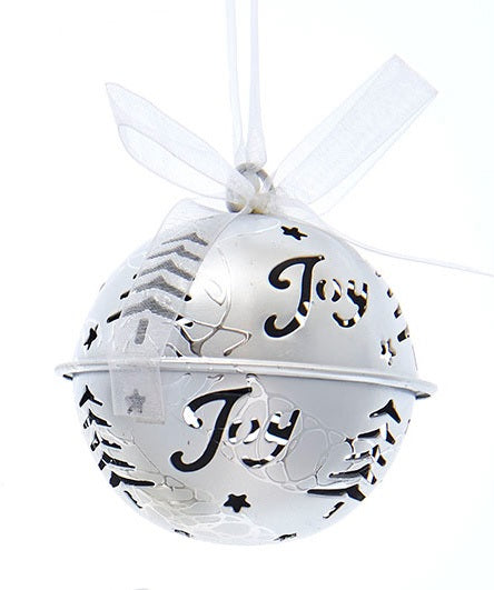 Silver bell ornament with tree and star cutouts and cutouts that read "JOY."