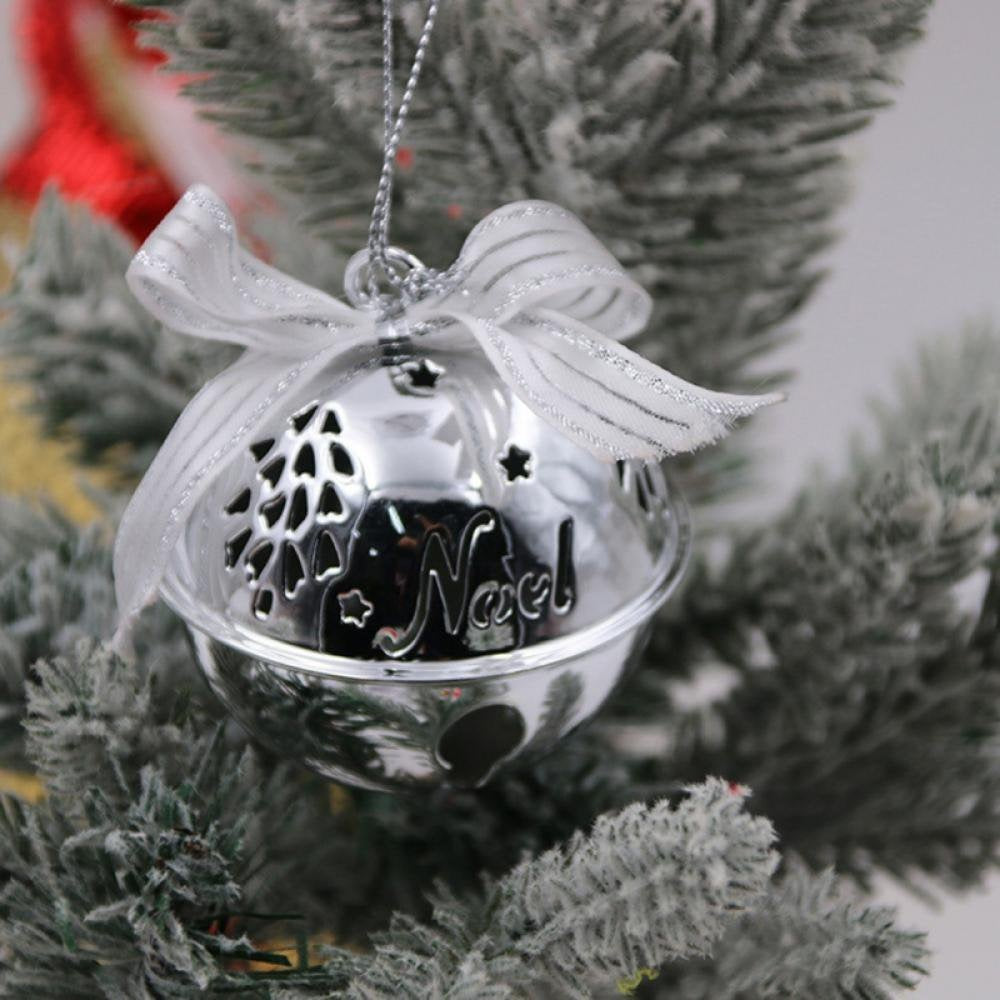 Silver bell ornament with tree and star cutouts and cutouts that read "NOEL."