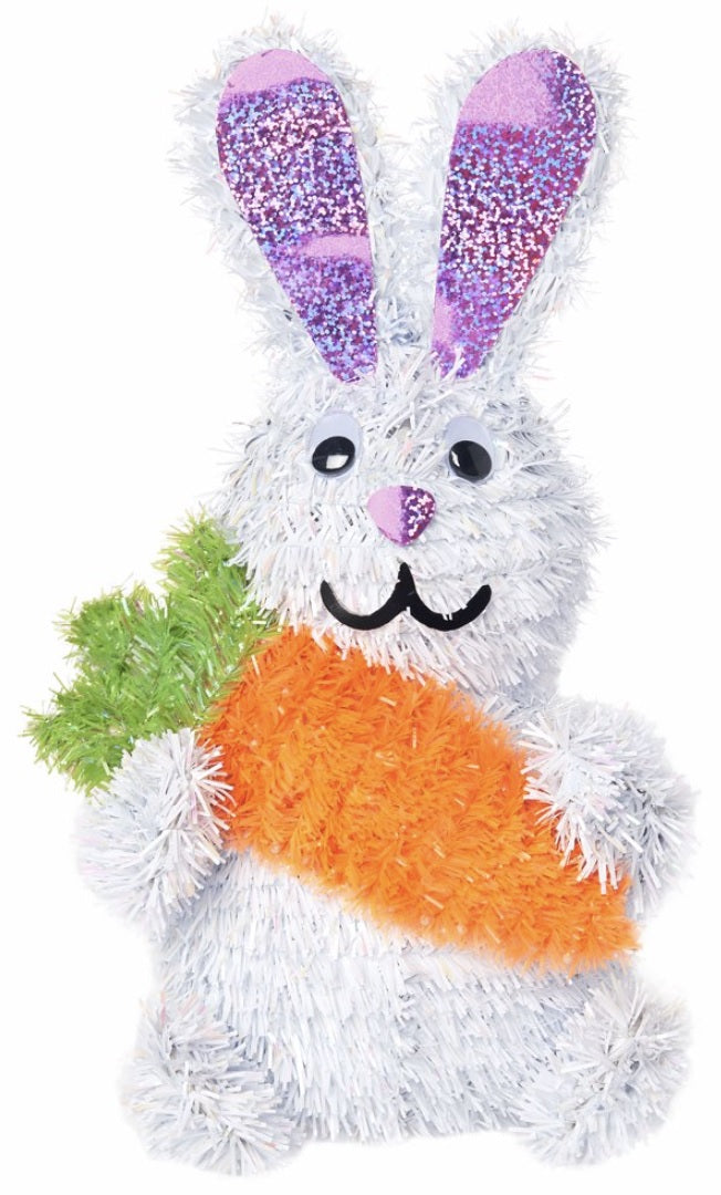 A 3D tinsel Easter bunny holding a big, orange carrot